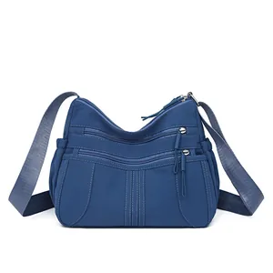 Large capacity lightweight blue multi-pocket nylon crossbody bag with wide shoulder strap