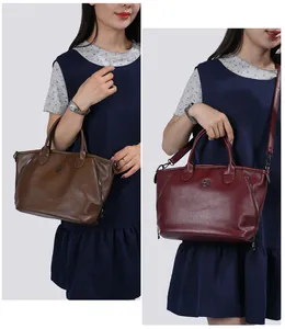 Detail view of two elegant vintage leather tote bags in stylish brown and burgundy colors.