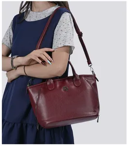Elegant burgundy large capacity faux leather shoulder bag shown on model in detailed view