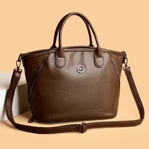 Elegant vintage brown faux leather handbag featuring dual handles and adjustable strap