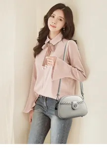 Lifestyle view of elegant soft leather crossbody bag with braided detail for women