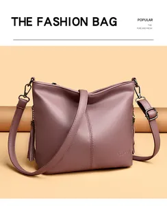 Close-up detail of a mauve pebbled leather bucket bag featuring elegant decorative tassels
