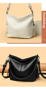 Detail of white and black pebbled leather bucket bags with tassels and adjustable straps.