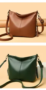 Detailed side view of textured leather hobo bags in brown and dark green colors