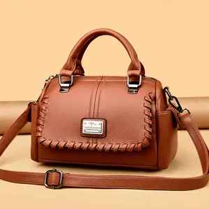 Elegant brown leather handbag for women with adjustable crossbody strap and top handle