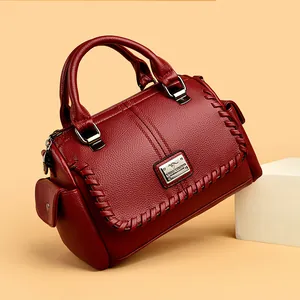 Elegant wine red faux leather handbag for women featuring braided detail and top handle