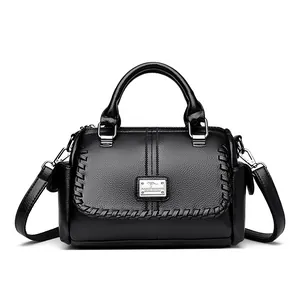 Elegant black textured leather handbag with top handle and adjustable shoulder strap