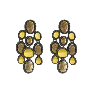 Close-up detail of vintage ethnic style drop earrings featuring yellow resin cabochons