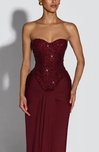 Elegant burgundy strapless dress with sequined bodice and draped skirt details for women