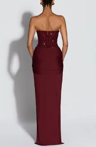 Back view of a burgundy strapless maxi dress with beaded bodice and ruched waist details.
