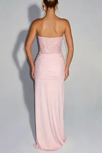 Back view of a pink strapless evening dress with sequined bodice and draped skirt.