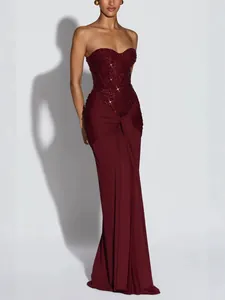 Elegant burgundy strapless evening gown with beaded corset and draped skirt detail