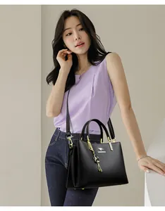 Detail view of elegance black leather handbag worn by Asian model