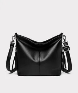Front view of black pebble leather bucket bag with tassel detail and shoulder strap.