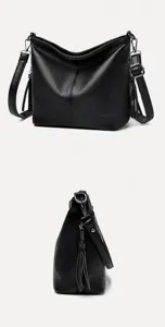 Side views of a black pebbled leather bucket bag with stylish tassel accents.