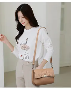 Fashionable women's tan shoulder bag featuring a crocodile texture flap and pebbled leather
