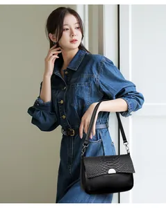 Black women's shoulder bag with a stylish crocodile-embossed flap detail and silver lock