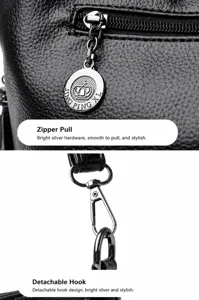 Detail view of high-quality metal zipper pull and detachable hook on black leather bag