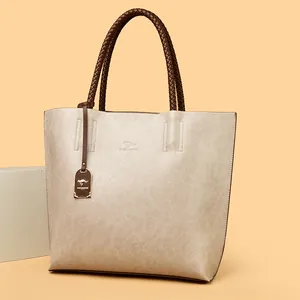 Stijlvolle beige grote dames shopper met gevlochten handvatten en kangoeroe-hanger