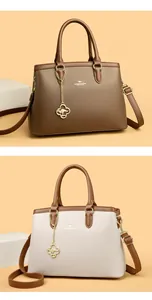 Detailansicht von zwei eleganten Leder-Handtaschen in den Farben Braun und Beige.