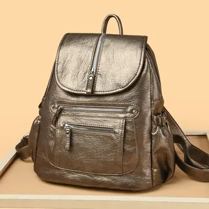 Sac à dos vintage chic en cuir souple bronze métallisé pour femme avec plusieurs zips