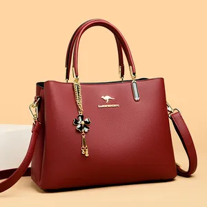 Elegant burgundy leather handbag for women with gold kangaroo logo and top handles