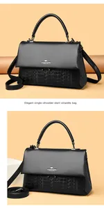 Elegant black leather handbag with kangaroo logo and embossed pattern detail