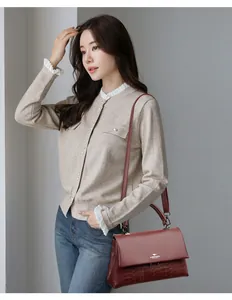 Elegant wine red handbag with top handle and kangaroo logo for professional women.