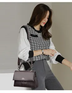 Elegant dark brown leather handbag for women with kangaroo logo and textured pattern detail