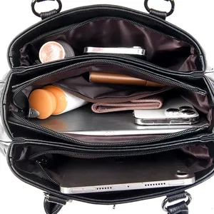 Spacious black multi-compartment handbag showing interior capacity for essentials