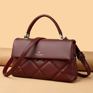 Elegant burgundy quilted leather handbag with crossbody strap and gold-tone buckle
