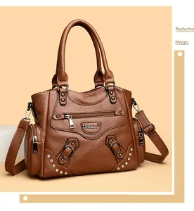 Détail frontal du sac cabas en cuir marron pour femme avec des rivets élégants