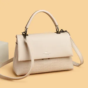 Elegant cream-colored leather handbag for women featuring a top handle and embossed pattern
