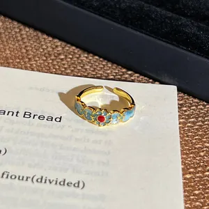 Nahaufnahme eines Vintage-Emaille-Blumenrings im orientalischen Stil mit blauen Blüten
