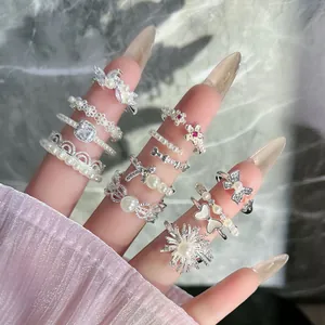 Detailed view of French vintage silver-finished rings with pearls and bow-tie floral patterns