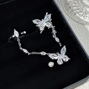 Close-up of elegant silver butterfly chain ring with shimmering cubic zirconia crystals