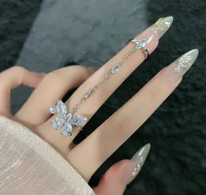 Close-up detail of silver butterfly chain ring with crystals and pearl for women