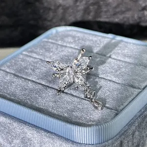 Detailed macro shot of a sparkling butterfly ring with tassels on a blue velvet box