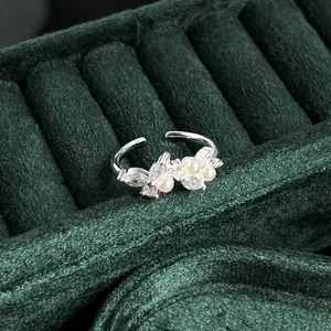 Detail view of a vintage silver adjustable ring featuring white pearls and marquise crystals.