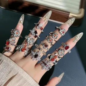 Exquisite macro detail of vintage garnet red flower rings on an elegant model hand