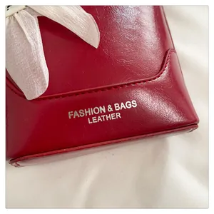 Close-up of red leather texture on a trendy bucket bag with Fashion & Bags logo.