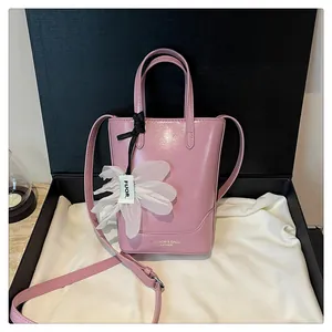 Elegant pink leather bucket bag for women displayed in a premium black gift box.