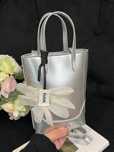 Stylish silver metallic crossbody bucket bag for women with elegant flower charm detail