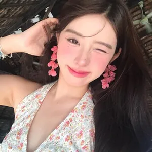 Stylish pink floral multi-layer drop earrings worn by a woman for a romantic look