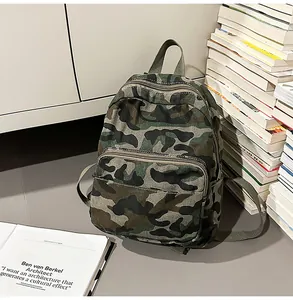 Detailed macro view of a camouflage casual backpack placed next to a stack of books
