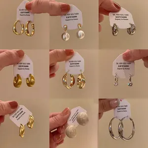 Nine-grid collection of Korean style zircon and pearl earrings on display cards