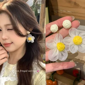 Close-up detail of soft white daisy floral drop earrings for women with nature-inspired design