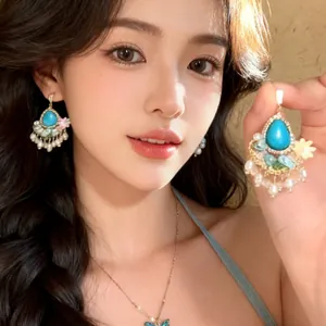 Detail of forest style floral earrings with turquoise drop and pearl fringe