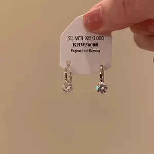 Elegant 925 silver hoop earrings featuring a sparkling round clear crystal pendant.