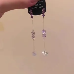 Elegant long drop earrings featuring purple crystals and a delicate silver chain